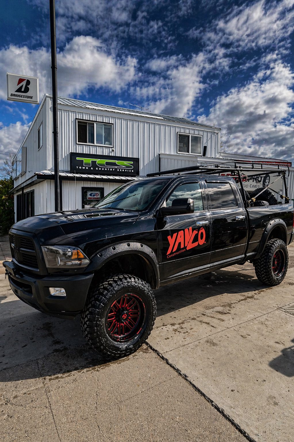 Custom setup1 TCS custom wheel and tire setup on modified vehicle, unique rim design with upgraded suspension and fitment, showcasing personalized automotive styling and performance